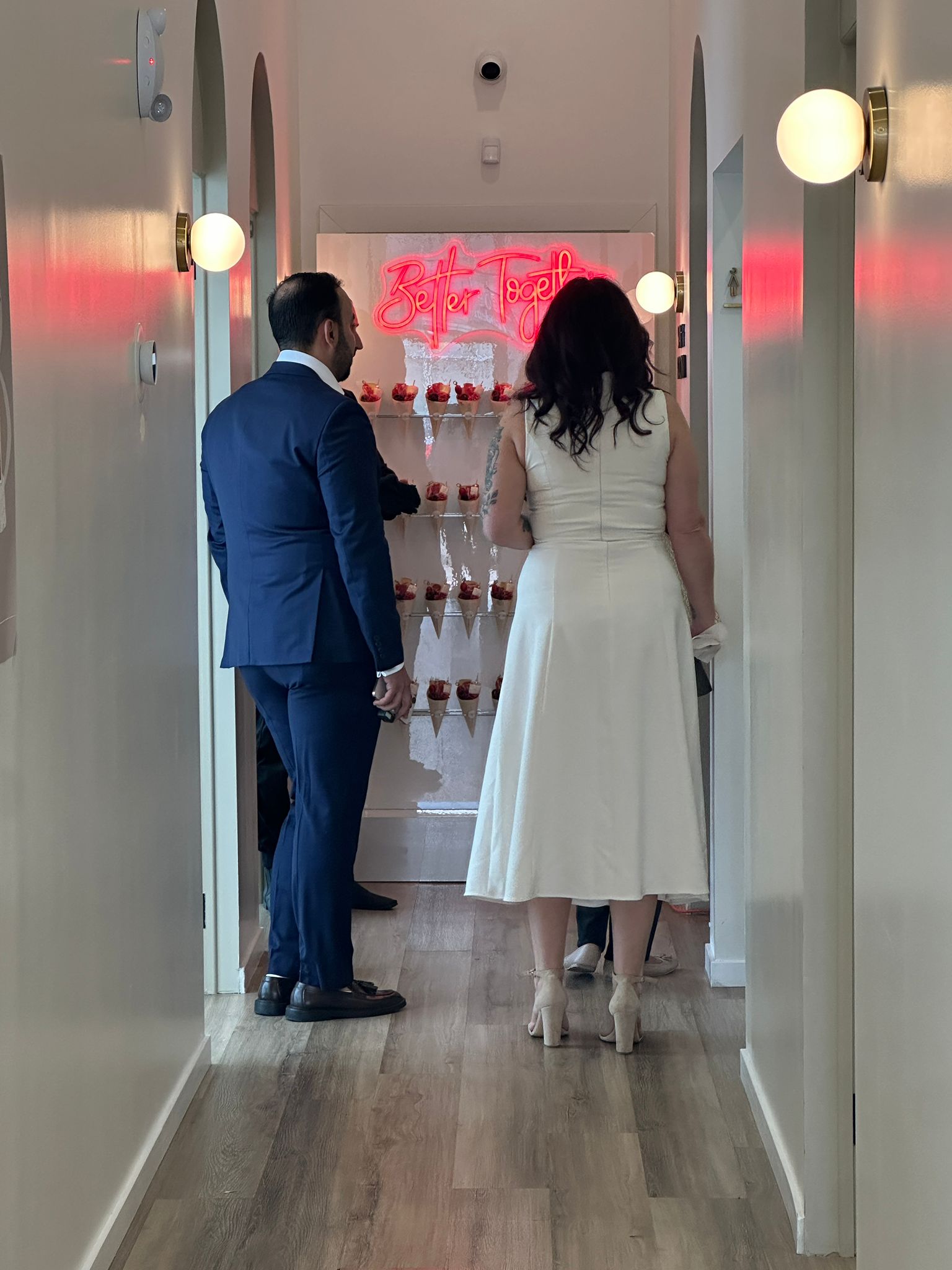 Guests gathering by the "Better Together" neon installation