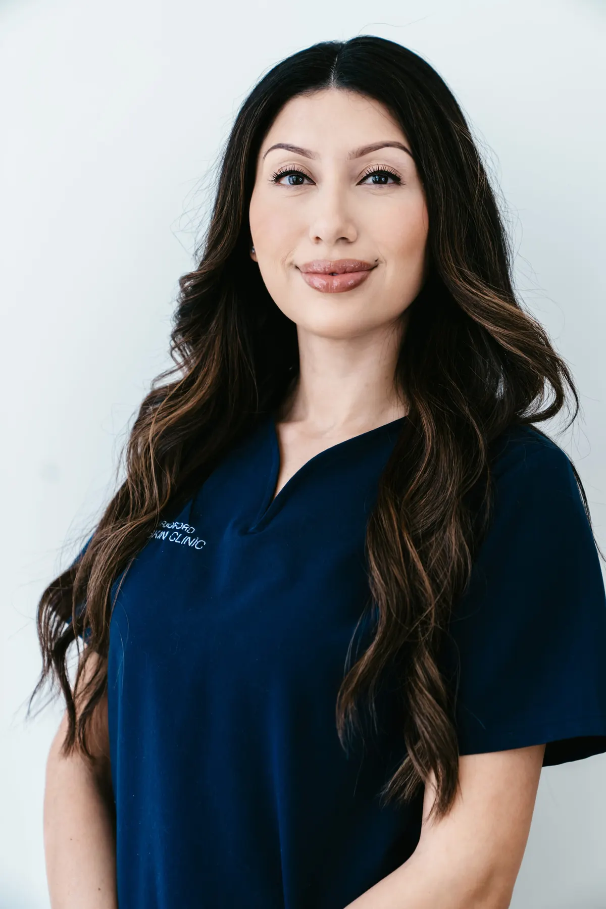 Ashley Bravo in navy Bradford Skin Clinic scrubs