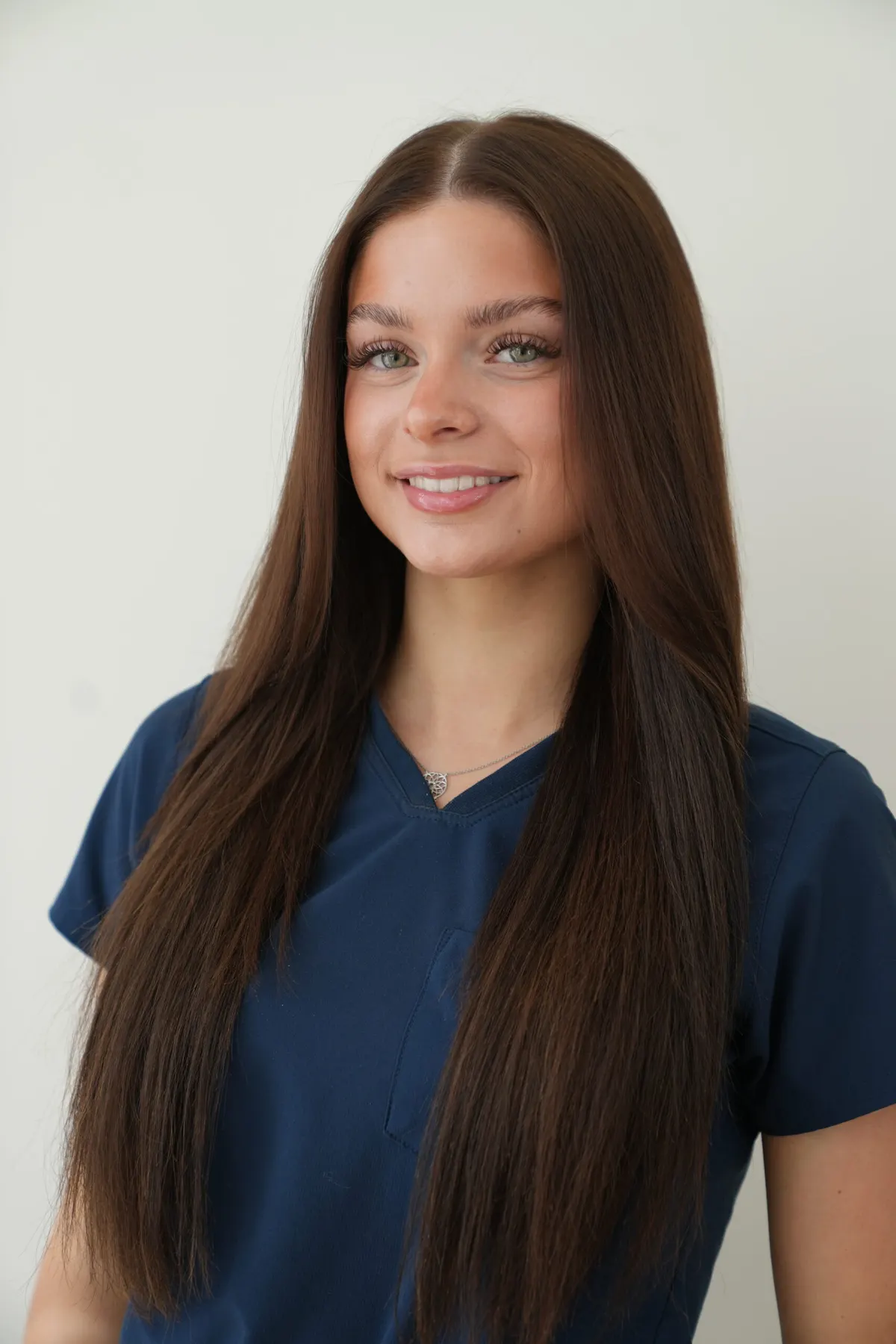 Maddie Lambert in navy Bradford Skin Clinic scrubs