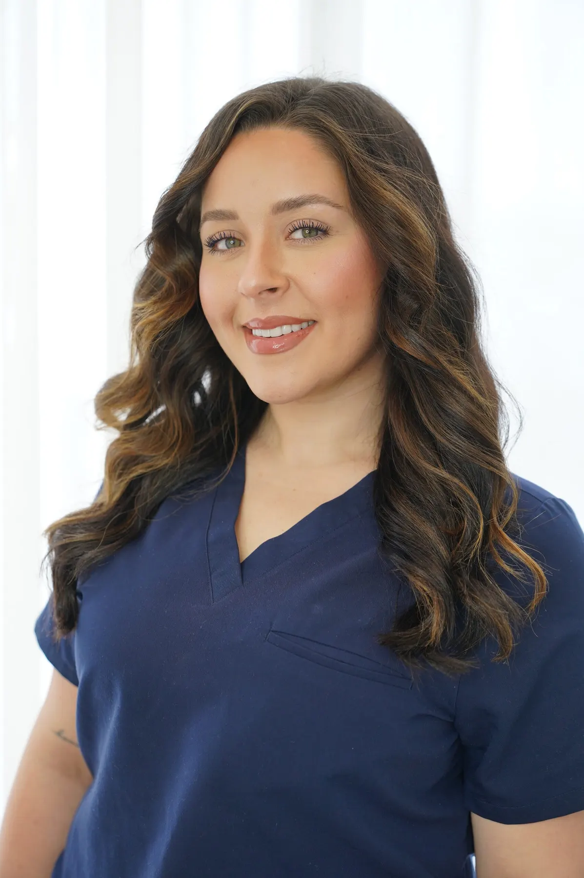 Kaitlyn Meli in navy Bradford Skin Clinic scrubs