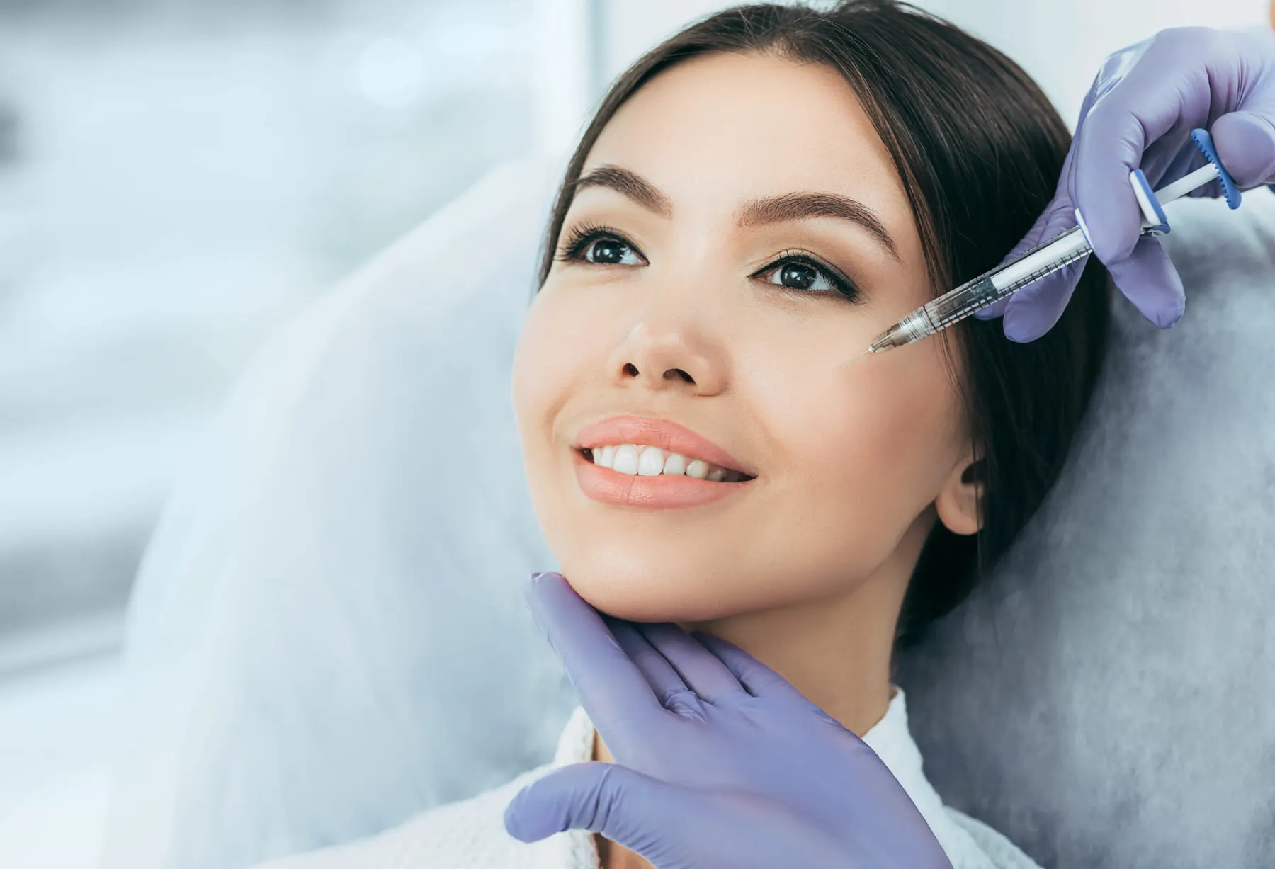 A client receiving an injectable treatment in a clinical setting