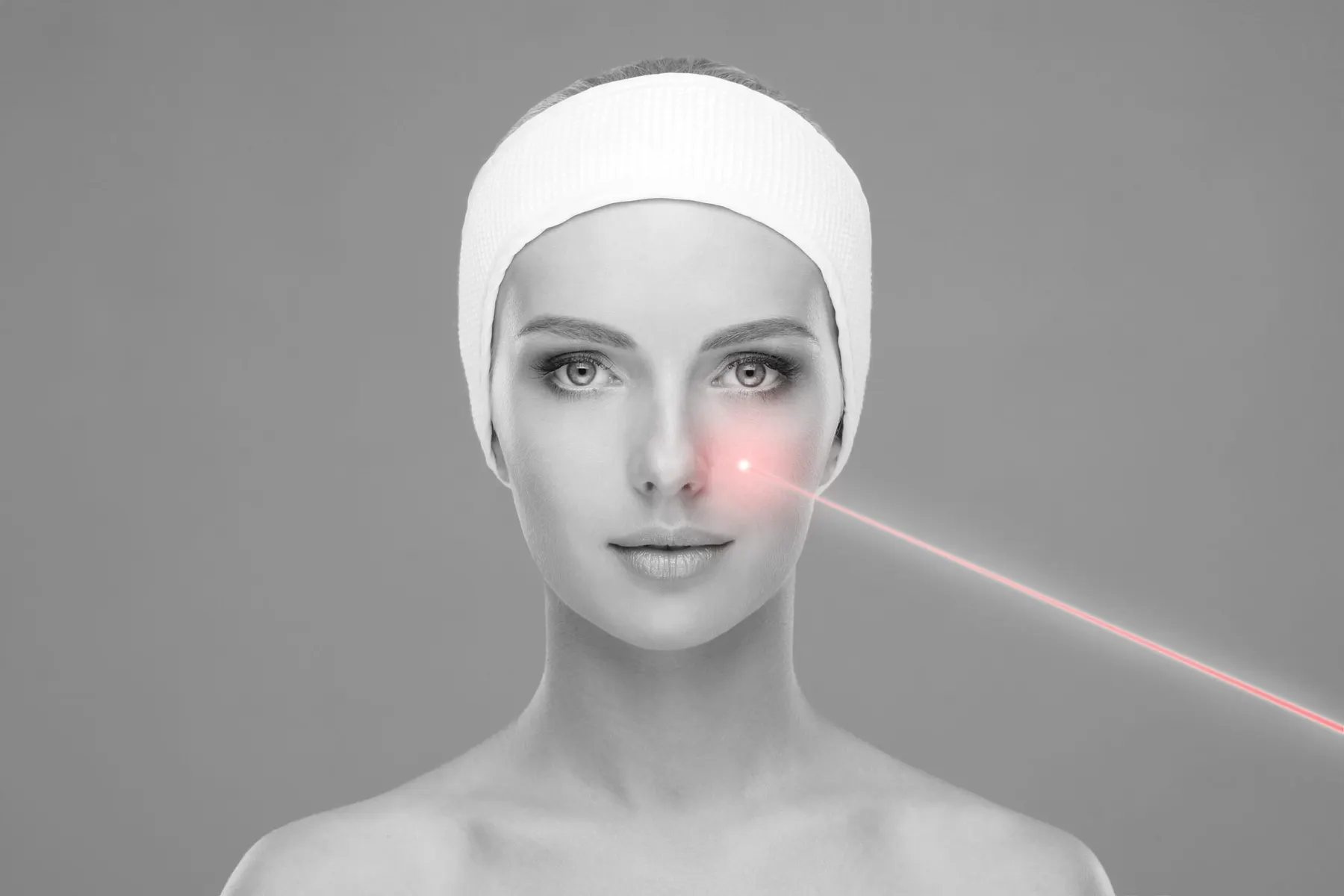 A client receiving a laser pass across carbon lotion applied to the face