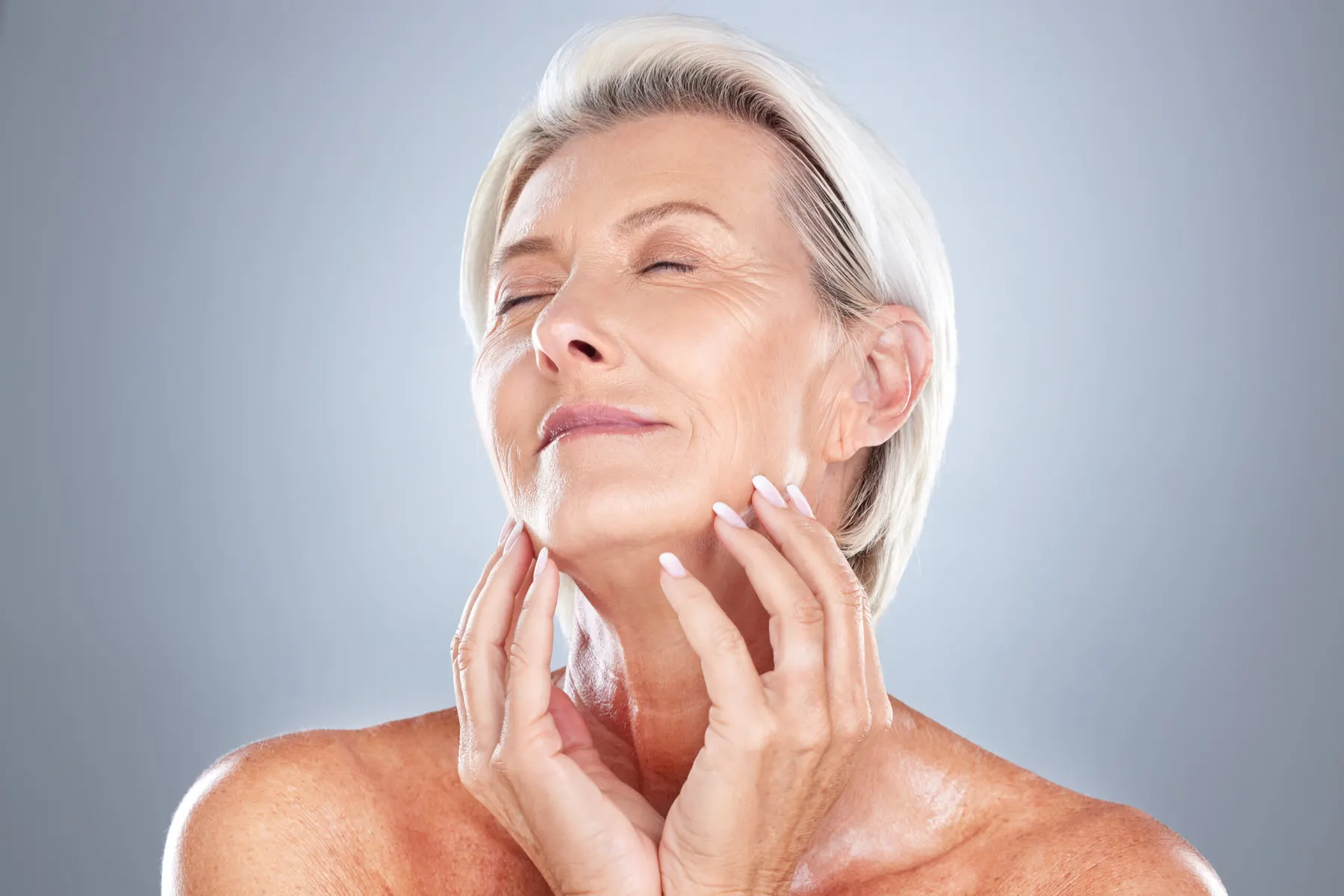 A mature woman relaxing during a skincare consultation at the clinic