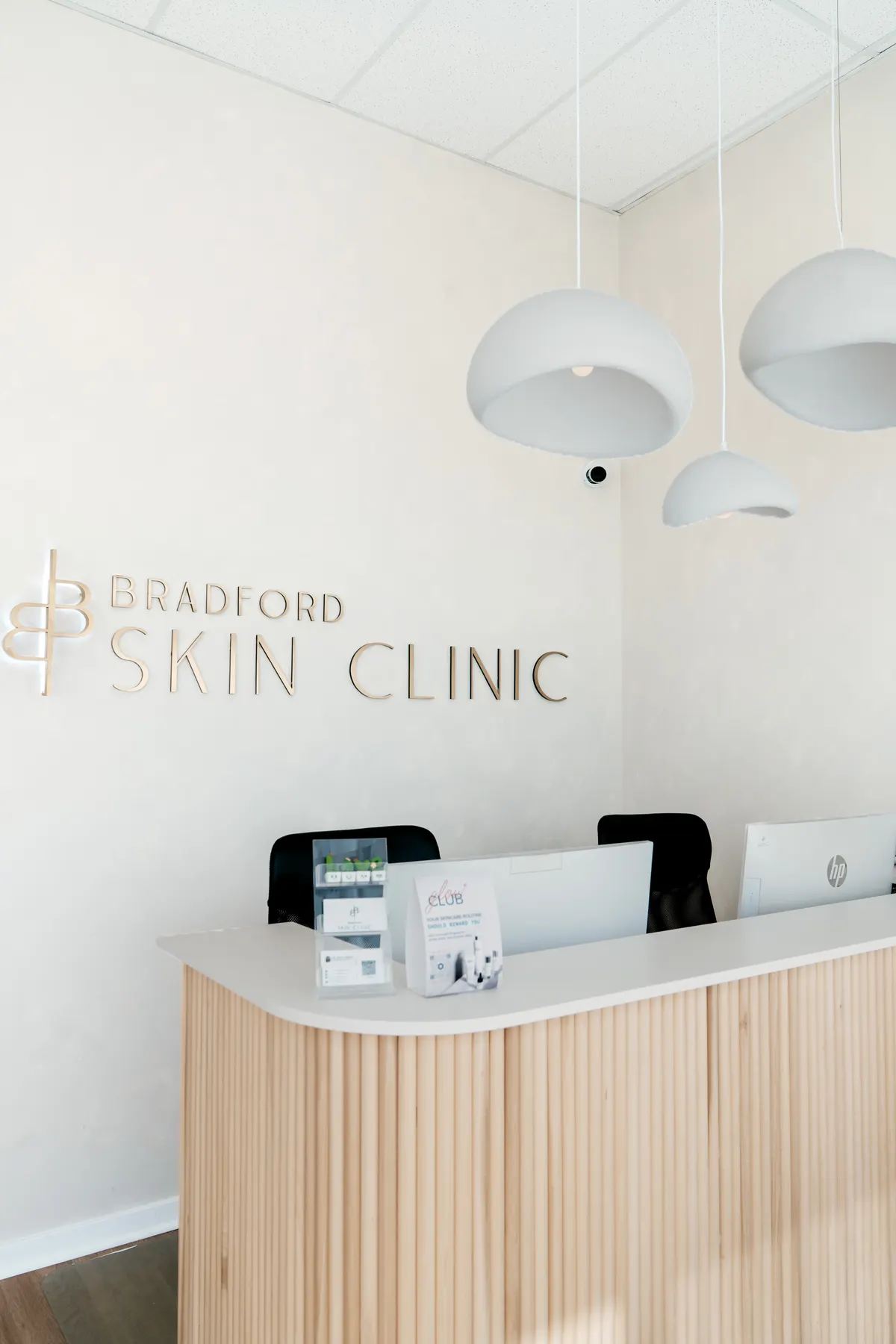 The reception desk at Bradford Skin Clinic with printed brochures on the counter
