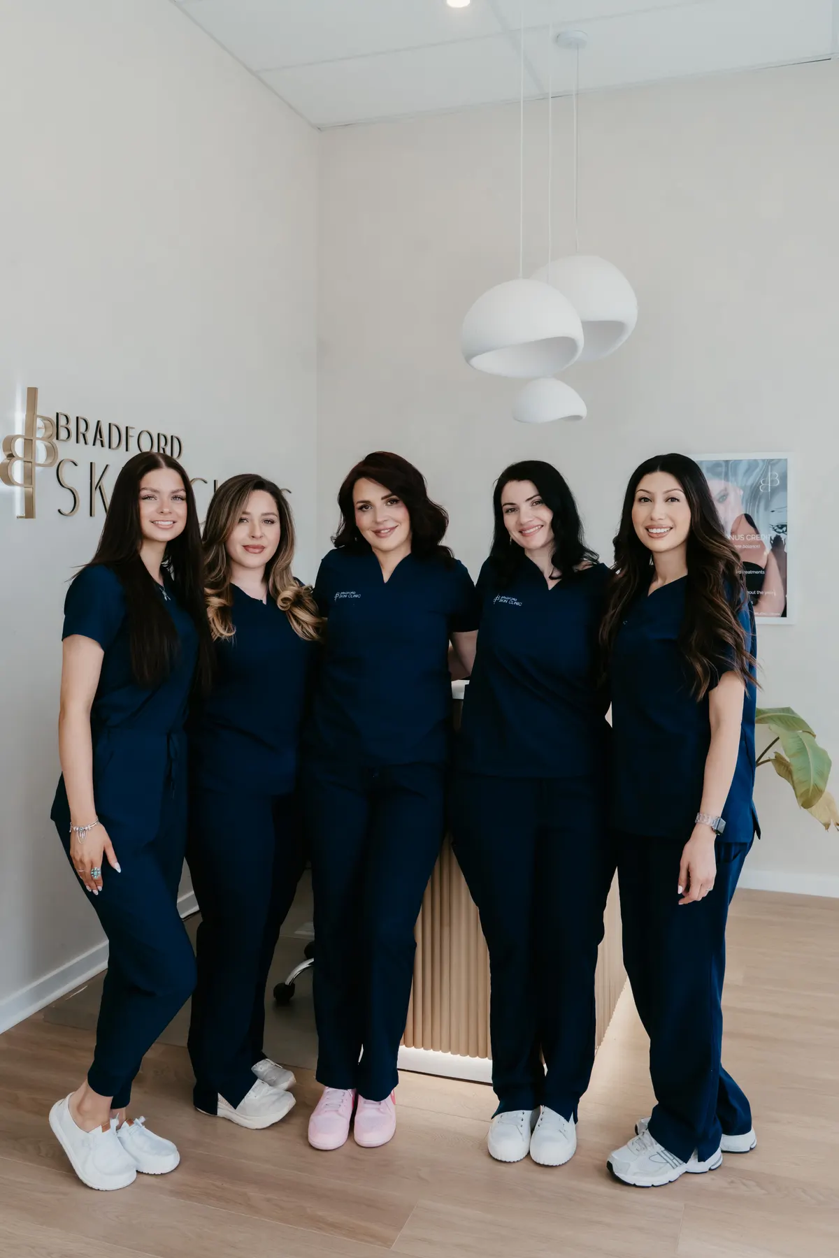 The Bradford Skin Clinic team in navy clinic scrubs